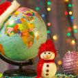 Globe with a Christmas hat and a festive snowman for Christmas activities in humanities